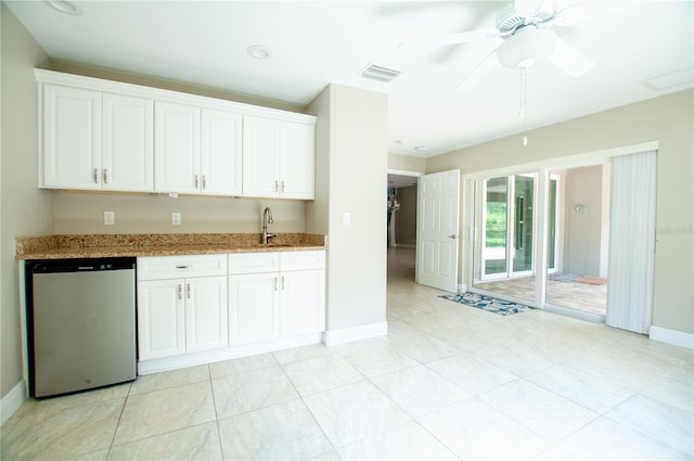 kitchen with a sink, dishwashing machine, light stone counters, and white cabinetry