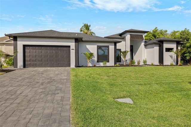 2716 SW 13th Ave, Cape Coral, FL 33914 - prairie-style home featuring a garage, stucco siding, decorative driveway, and a front lawn
