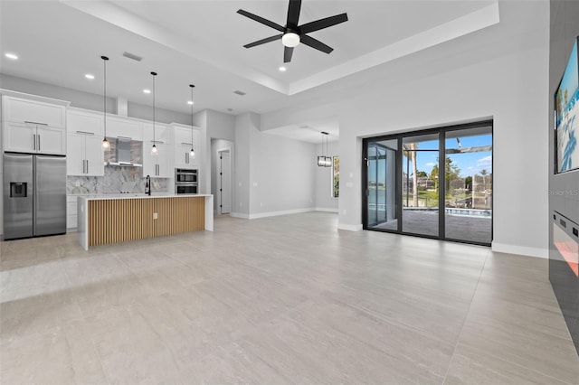 2716 SW 13th Ave, Cape Coral, FL 33914 - unfurnished living room with a ceiling fan, visible vents, baseboards, a tray ceiling, and recessed lighting