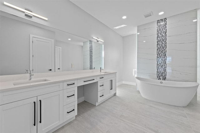 2716 SW 13th Ave, Cape Coral, FL 33914 - bathroom with a soaking tub, a sink, visible vents, and double vanity