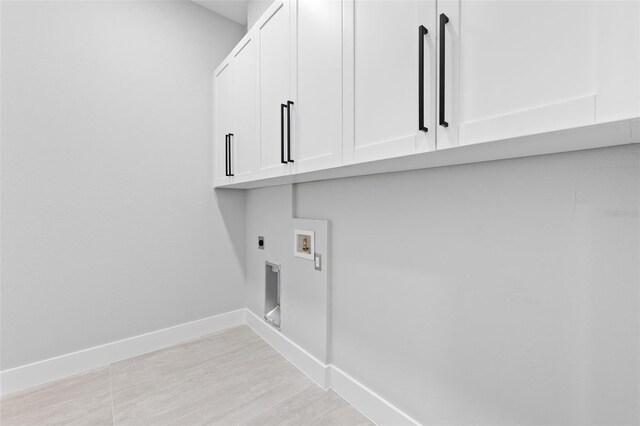 2716 SW 13th Ave, Cape Coral, FL 33914 - washroom with baseboards, hookup for a washing machine, light wood-style floors, cabinet space, and electric dryer hookup