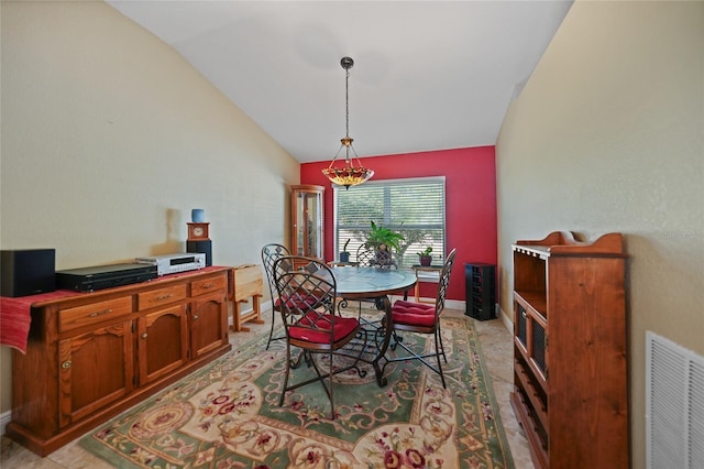dining room featuring visible vents, baseboards, and lofted ceiling