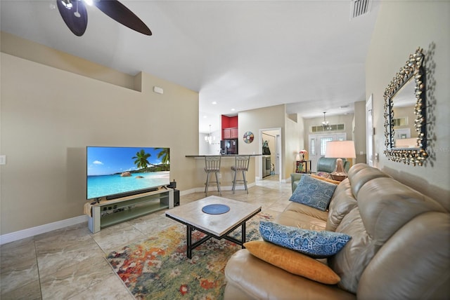 living area with visible vents, baseboards, and ceiling fan