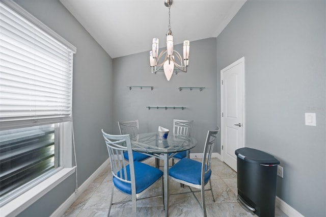 dining room featuring baseboards, a chandelier, and vaulted ceiling