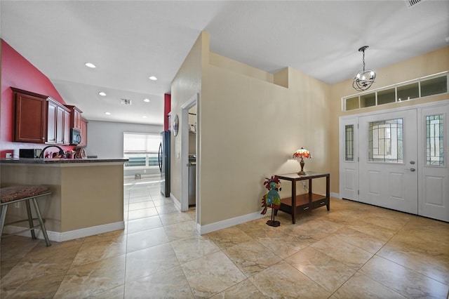 foyer with visible vents, a notable chandelier, recessed lighting, baseboards, and vaulted ceiling