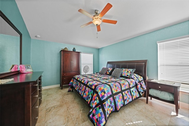 bedroom with a ceiling fan and baseboards