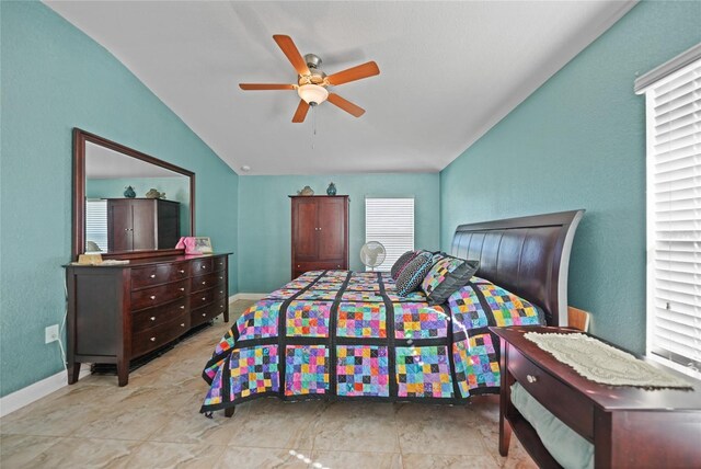bedroom with vaulted ceiling, baseboards, and ceiling fan