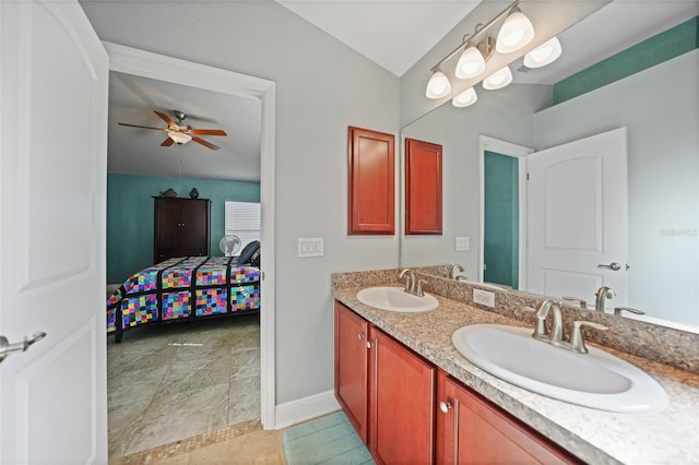 ensuite bathroom featuring double vanity, ensuite bathroom, ceiling fan, and a sink