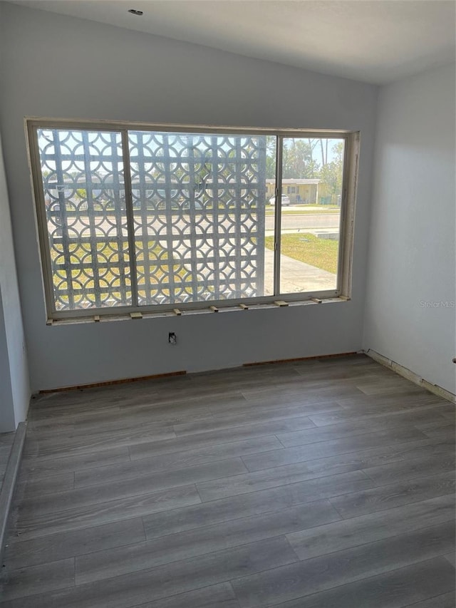 spare room featuring wood finished floors