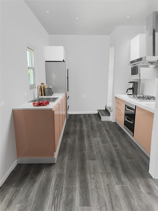 kitchen with wall chimney range hood, modern cabinets, wall oven, and a sink