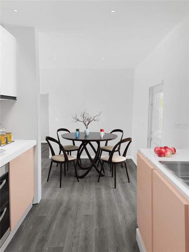 dining space featuring dark wood-style flooring, baseboards, and recessed lighting