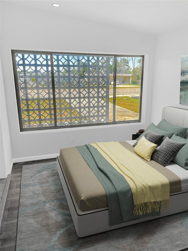 bedroom featuring recessed lighting, multiple windows, baseboards, and wood finished floors