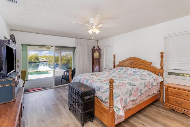 535 Ramblewood St, Port Charlotte, FL 33953 - bedroom featuring a textured ceiling, access to exterior, wood finished floors, and ceiling fan