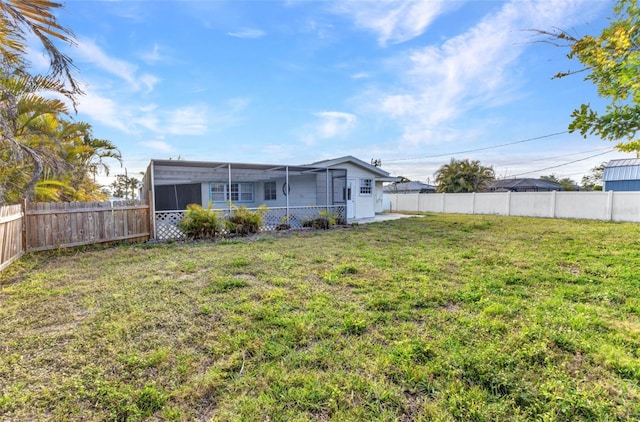 view of yard with a fenced backyard and a sunroom