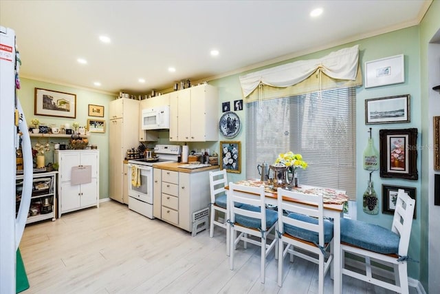 105 Clubhouse Dr Unit D155, Naples, FL 34105 - kitchen featuring white appliances, light wood finished floors, recessed lighting, ornamental molding, and white cabinets