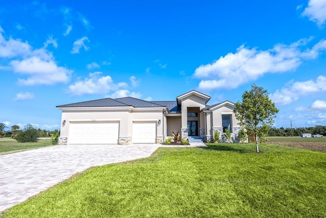 prairie-style home with stucco siding, decorative driveway, a front yard, an attached garage, and metal roof