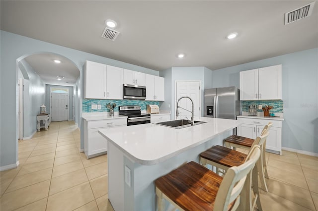 kitchen featuring a sink, visible vents, appliances with stainless steel finishes, and light countertops