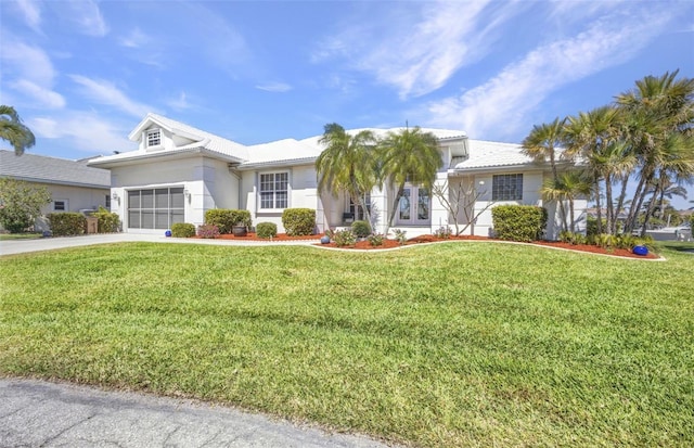 412 Panarea Dr, Punta Gorda, FL 33950 - view of front of house featuring a tiled roof, an attached garage, concrete driveway, and a front yard