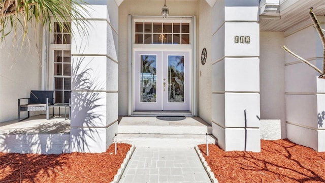412 Panarea Dr, Punta Gorda, FL 33950 - view of exterior entry featuring stucco siding and french doors