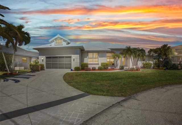 412 Panarea Dr, Punta Gorda, FL 33950 - view of front facade with a front yard, driveway, an attached garage, stucco siding, and a tile roof