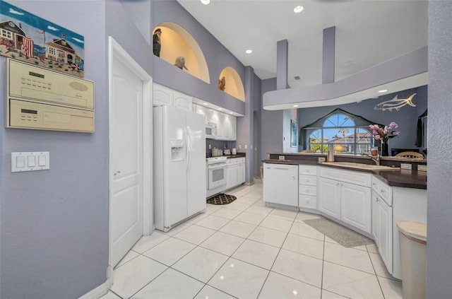 412 Panarea Dr, Punta Gorda, FL 33950 - kitchen featuring a sink, dark countertops, white cabinetry, white appliances, and light tile patterned flooring