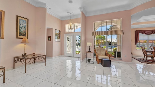 412 Panarea Dr, Punta Gorda, FL 33950 - tiled foyer with baseboards, an inviting chandelier, french doors, a towering ceiling, and crown molding