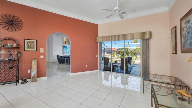 412 Panarea Dr, Punta Gorda, FL 33950 - unfurnished room featuring light tile patterned floors, baseboards, arched walkways, ceiling fan, and ornamental molding