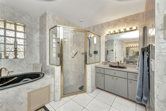 412 Panarea Dr, Punta Gorda, FL 33950 - full bath with a stall shower, tile walls, vanity, and a garden tub