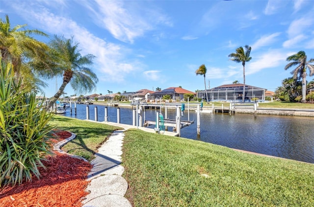 412 Panarea Dr, Punta Gorda, FL 33950 - dock area featuring boat lift, a residential view, a yard, and a water view