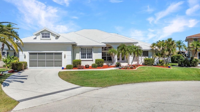412 Panarea Dr, Punta Gorda, FL 33950 - view of front of house featuring a front yard, driveway, an attached garage, stucco siding, and a tile roof