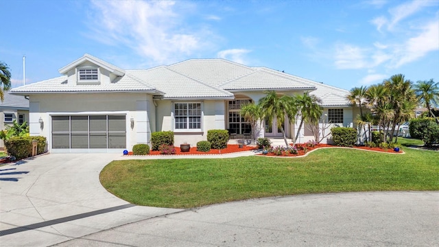 412 Panarea Dr, Punta Gorda, FL 33950 - view of front of home featuring a front yard, driveway, stucco siding, a garage, and a tiled roof