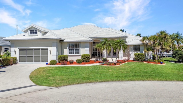 412 Panarea Dr, Punta Gorda, FL 33950 - view of front facade with a front lawn, a tile roof, concrete driveway, stucco siding, and an attached garage