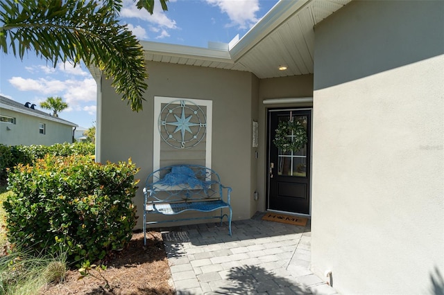 property entrance with stucco siding