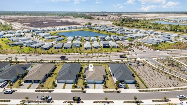 birds eye view of property with a residential view and a water view