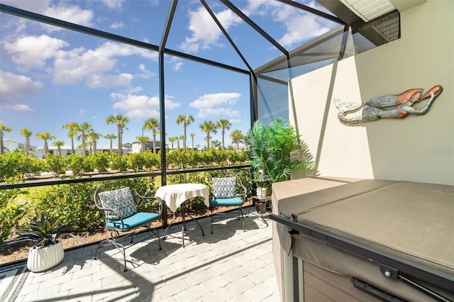 view of patio featuring a lanai and a hot tub