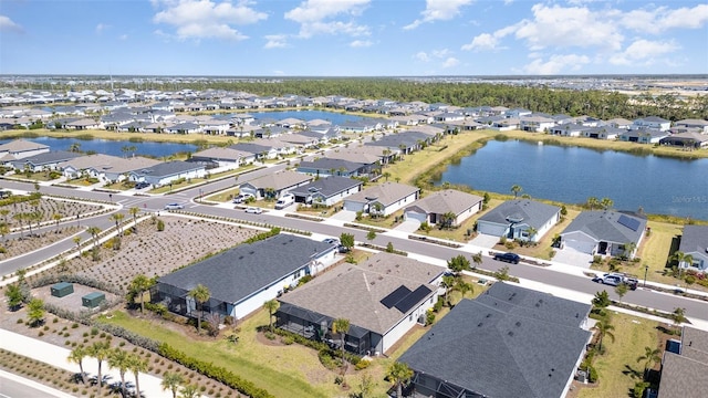 drone / aerial view featuring a residential view and a water view