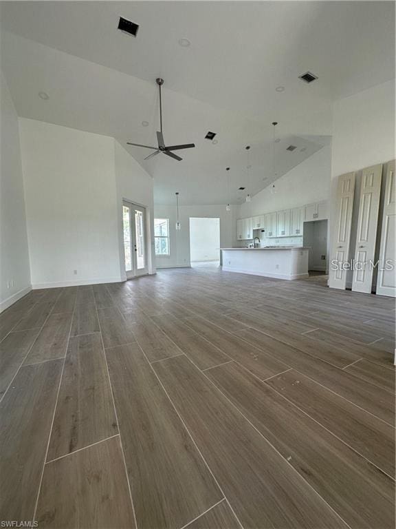8136 Sweden Blvd, Punta Gorda, FL 33982 - unfurnished living room featuring visible vents, high vaulted ceiling, a ceiling fan, wood finished floors, and french doors