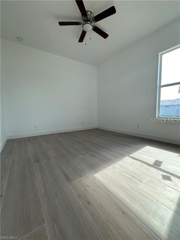8136 Sweden Blvd, Punta Gorda, FL 33982 - empty room featuring baseboards, wood finished floors, and a ceiling fan