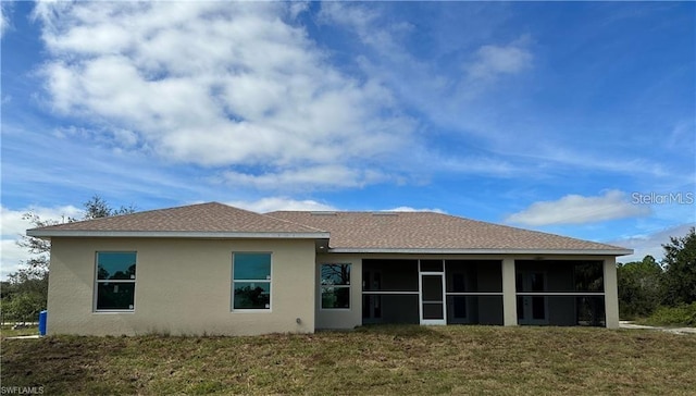 8136 Sweden Blvd, Punta Gorda, FL 33982 - rear view of property featuring stucco siding, a lawn, a shingled roof, and a sunroom