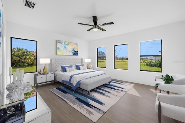24259 Peppercorn Rd, Punta Gorda, FL 33955 - bedroom with visible vents, multiple windows, dark wood-type flooring, and ceiling fan