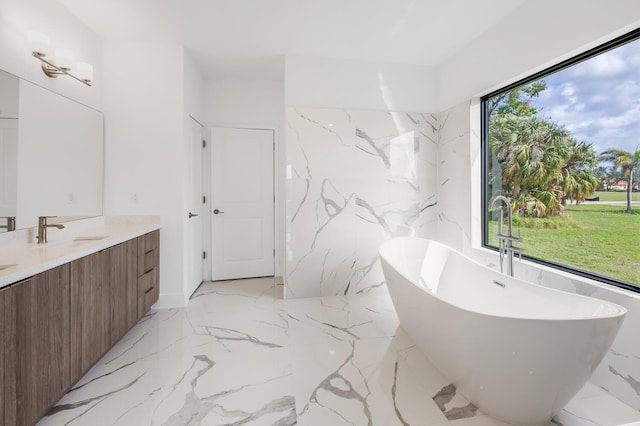 24259 Peppercorn Rd, Punta Gorda, FL 33955 - bathroom featuring vanity, a soaking tub, stone wall, and marble finish floor
