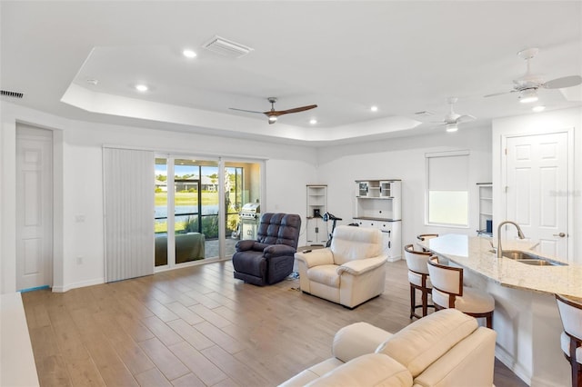 15931 Sugar Hill Dr, Punta Gorda, FL 33982 - living room featuring a tray ceiling, baseboards, a ceiling fan, and visible vents