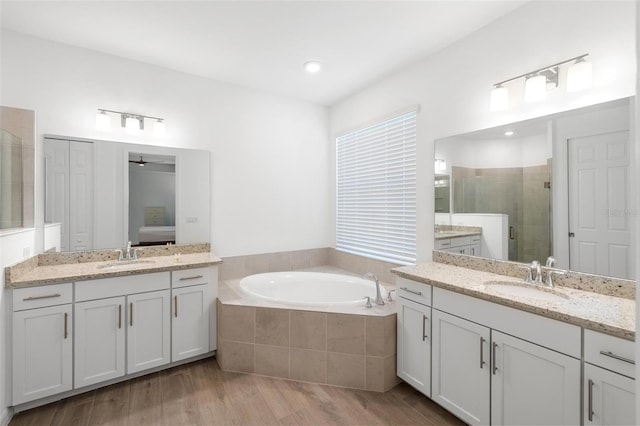 15931 Sugar Hill Dr, Punta Gorda, FL 33982 - full bath with a bath, a stall shower, wood finished floors, and a sink
