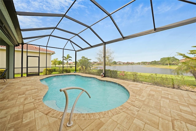 pool with glass enclosure, a water view, and a patio area