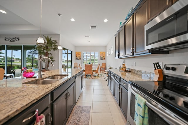 kitchen with a sink, appliances with stainless steel finishes, light tile patterned floors, visible vents, and recessed lighting