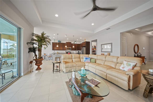living area with recessed lighting, a tray ceiling, visible vents, and ceiling fan