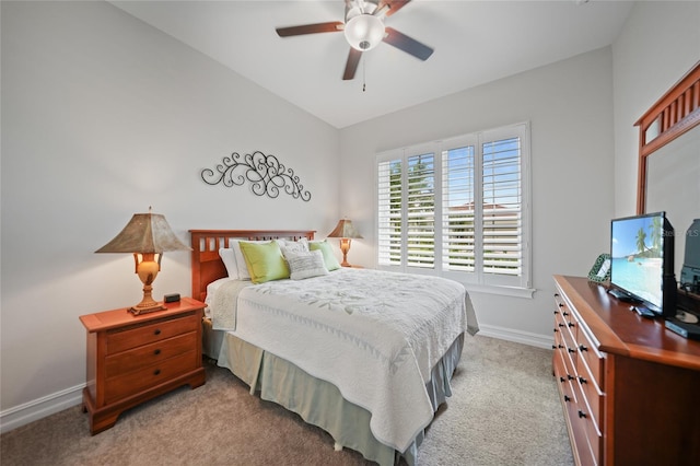 bedroom featuring light carpet, baseboards, and ceiling fan
