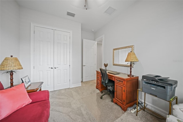 office space with light carpet, baseboards, and visible vents
