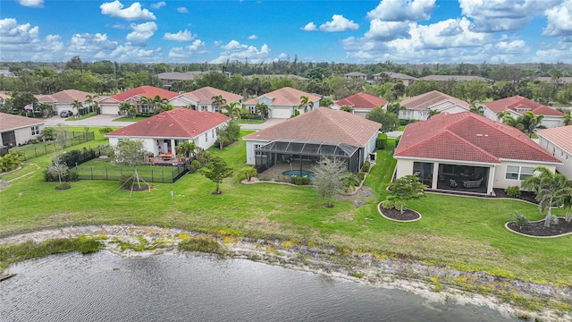 birds eye view of property with a water view and a residential view