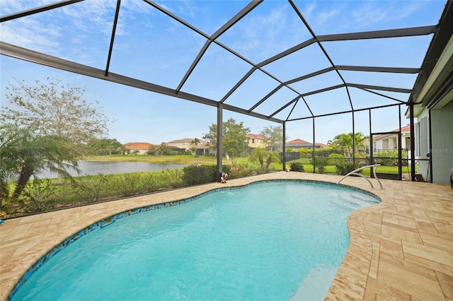 pool with glass enclosure, a water view, and a patio
